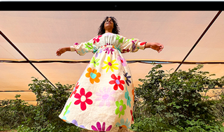 MacBook Air screen showing photo of person in colorful outfit, demonstrating color range and resolution of Liquid Retina display